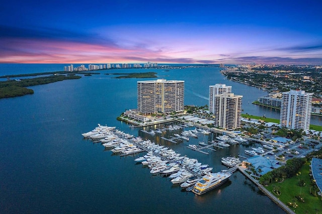 aerial view at dusk featuring a water view