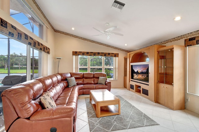 tiled living room featuring lofted ceiling, crown molding, and ceiling fan