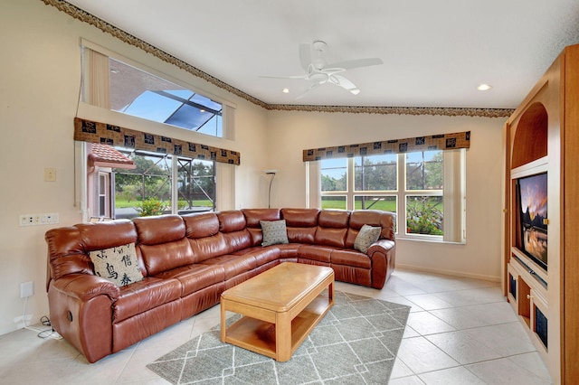 living room with ceiling fan, vaulted ceiling, and light tile patterned floors