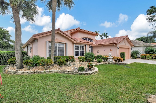 mediterranean / spanish home featuring a front yard and a garage