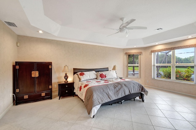 bedroom featuring a tray ceiling and ceiling fan