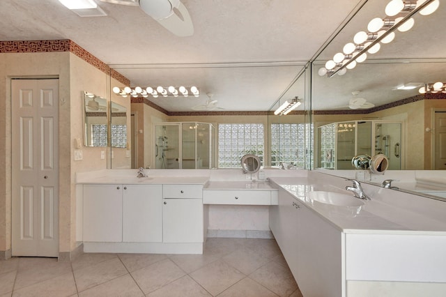 bathroom featuring vanity, a textured ceiling, separate shower and tub, and tile patterned flooring