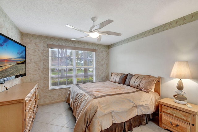 tiled bedroom featuring a textured ceiling and ceiling fan