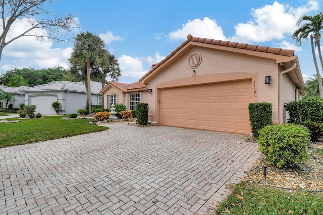 view of front of home with a front yard and a garage