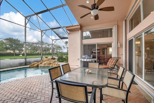 view of patio / terrace featuring a lanai, grilling area, and ceiling fan