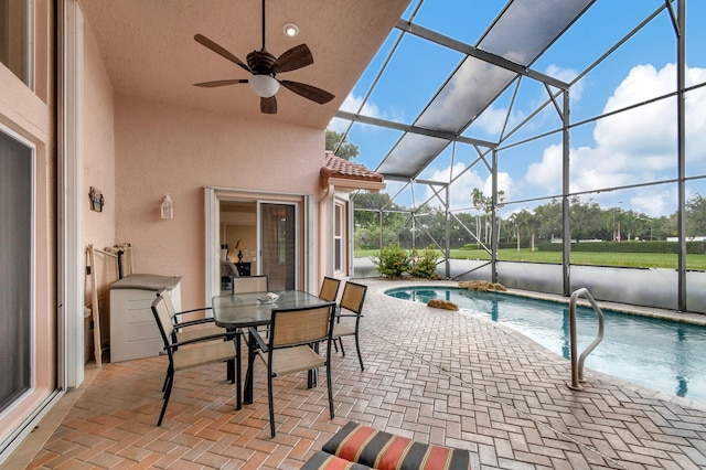 view of pool featuring ceiling fan, a lanai, and a patio area