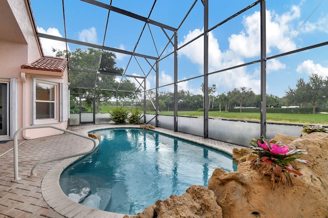 view of swimming pool featuring a patio and glass enclosure