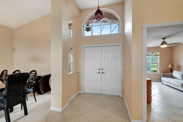 entrance foyer with light tile patterned floors and ceiling fan