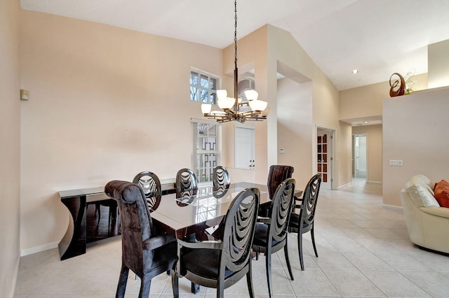 tiled dining room with high vaulted ceiling and a chandelier