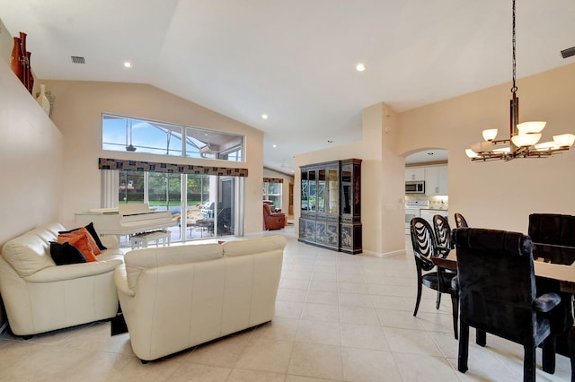 living room featuring vaulted ceiling, a notable chandelier, and light tile patterned floors