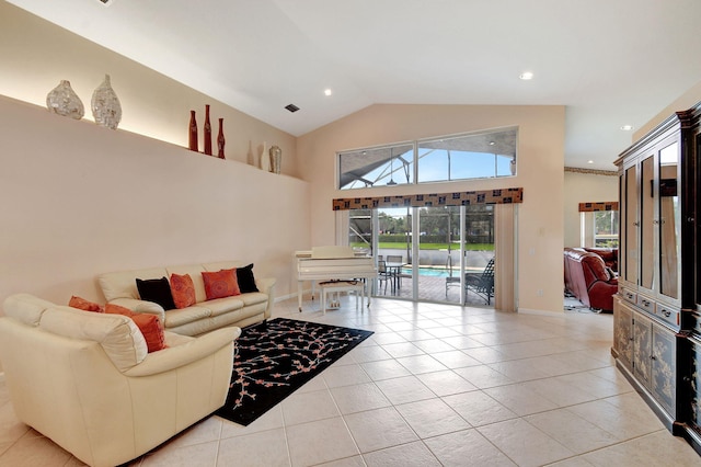 living room with vaulted ceiling and light tile patterned floors