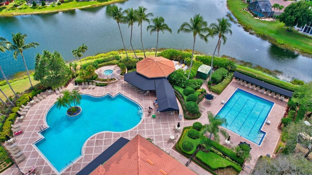 view of swimming pool with a patio and a water view