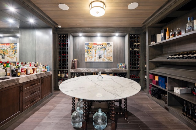 wine room featuring wood ceiling and sink