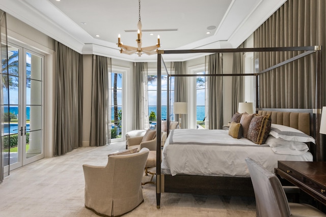 bedroom featuring french doors, a water view, access to exterior, and carpet flooring