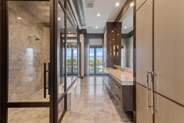 bathroom featuring vanity, a shower, and expansive windows