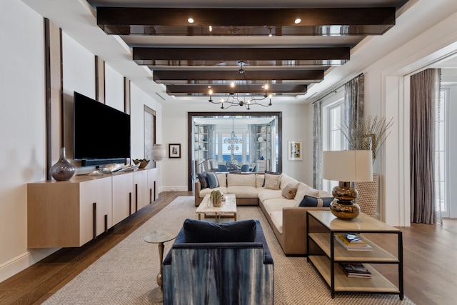 living room featuring a notable chandelier, hardwood / wood-style flooring, and beamed ceiling