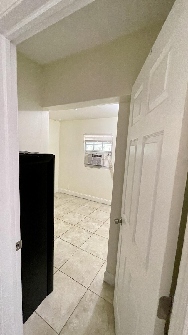 hallway with cooling unit, baseboards, and light tile patterned flooring