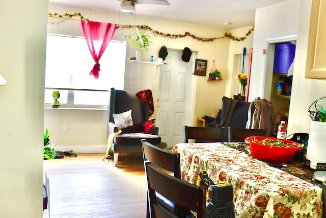 dining room featuring baseboards, wood finished floors, and a ceiling fan