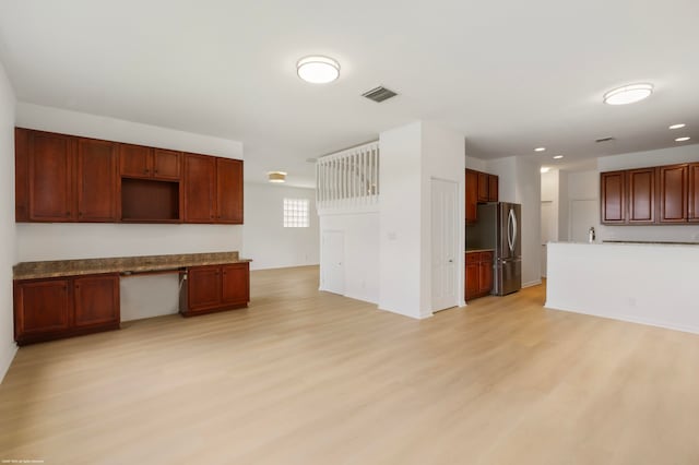 kitchen with stainless steel fridge and light wood-type flooring