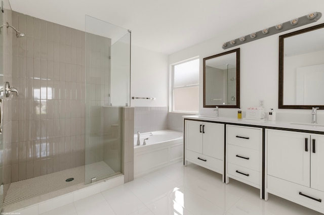 bathroom featuring tile patterned flooring, vanity, and separate shower and tub