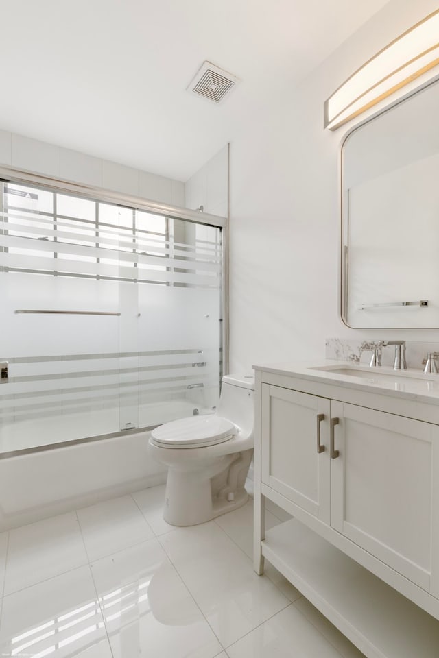 full bathroom with tile patterned flooring, vanity, toilet, and enclosed tub / shower combo