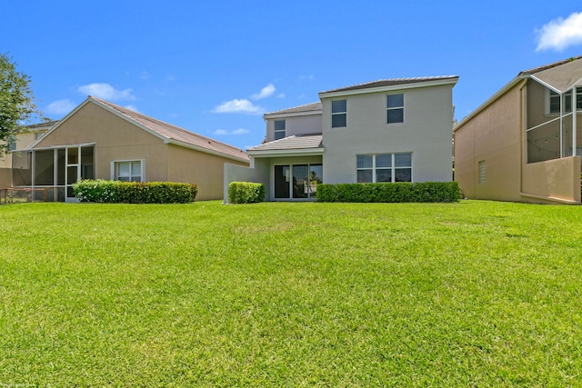 rear view of property with a lawn