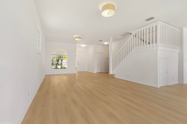 unfurnished living room featuring light wood-type flooring