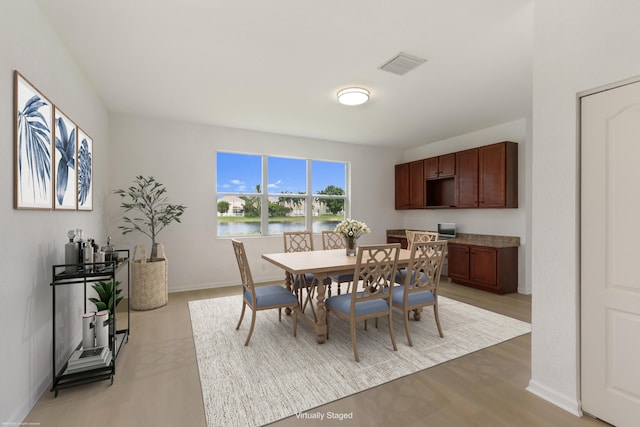 dining space featuring light wood-type flooring