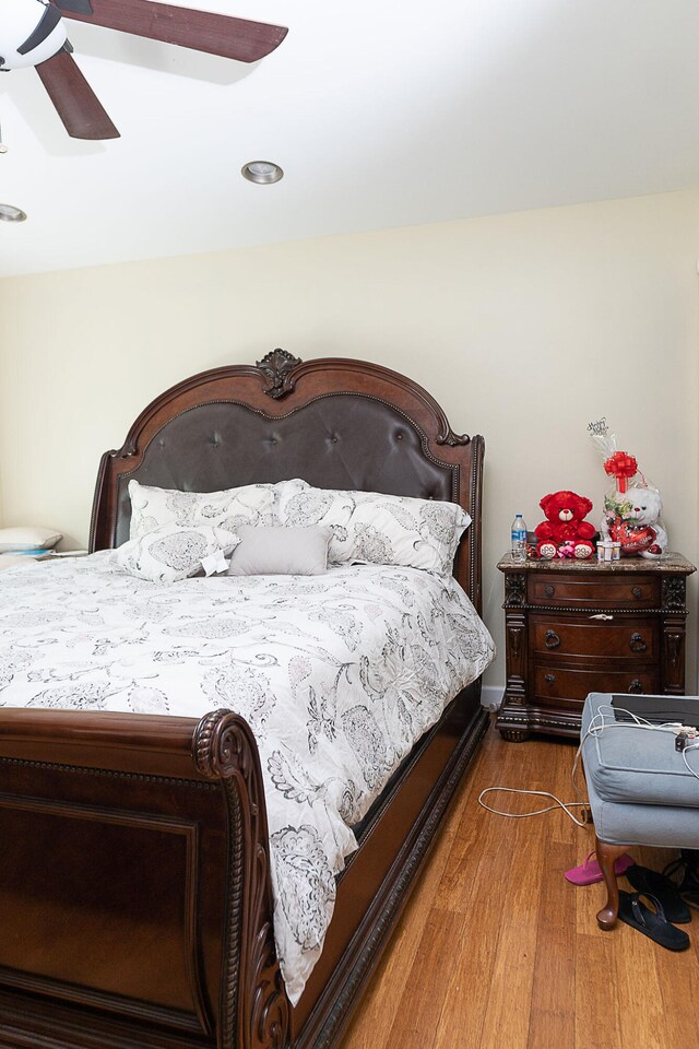 bedroom with ceiling fan and dark hardwood / wood-style floors