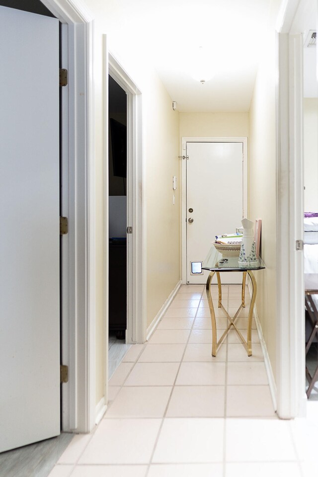 corridor featuring light tile patterned flooring