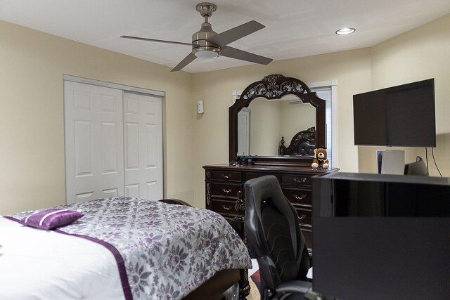 bedroom with ceiling fan and a closet