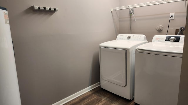 clothes washing area featuring dark hardwood / wood-style flooring and separate washer and dryer