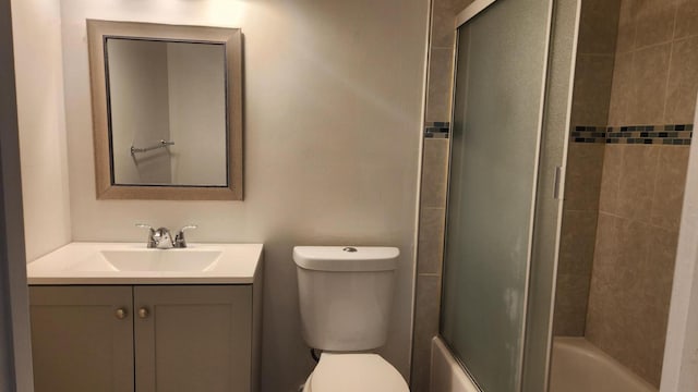 full bathroom featuring shower / bath combination with glass door, vanity, and toilet