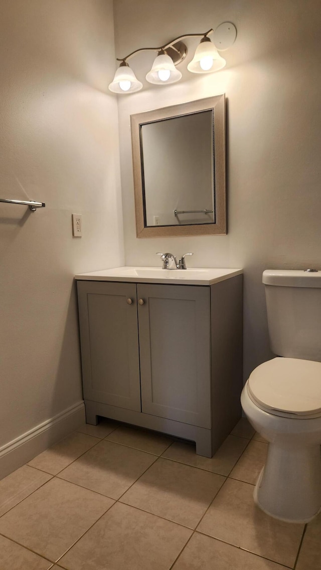 bathroom with tile patterned flooring, vanity, and toilet