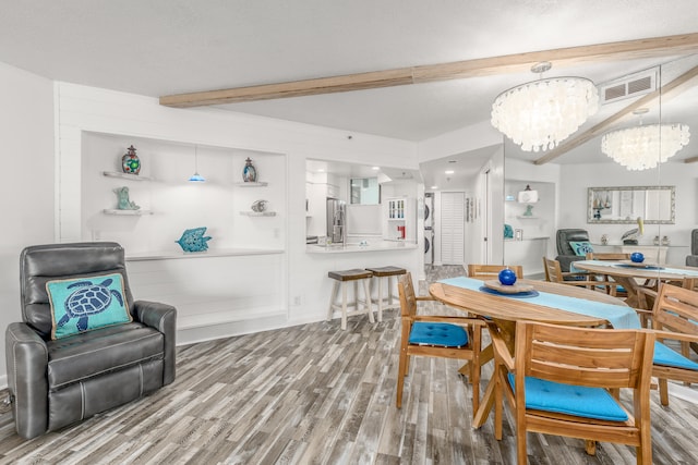 dining room featuring hardwood / wood-style flooring, a chandelier, and a textured ceiling