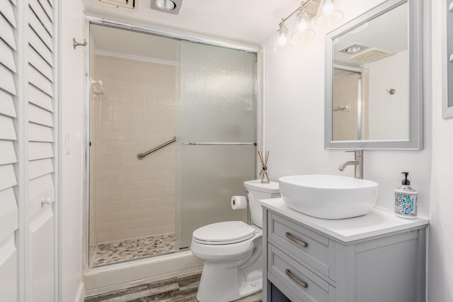 bathroom featuring hardwood / wood-style floors, toilet, a shower with door, and vanity