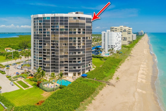 view of building exterior featuring a view of the beach and a water view