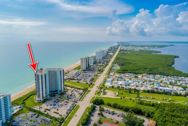 birds eye view of property with a water view and a view of the beach