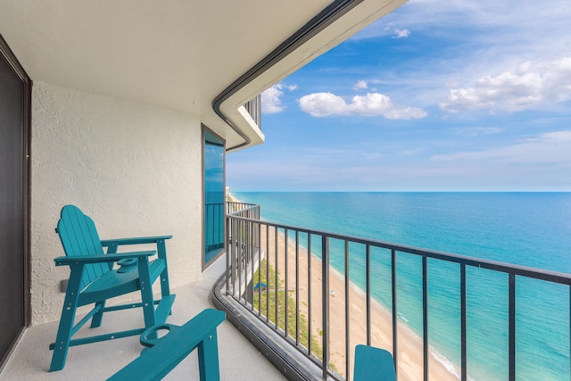 balcony with a beach view and a water view