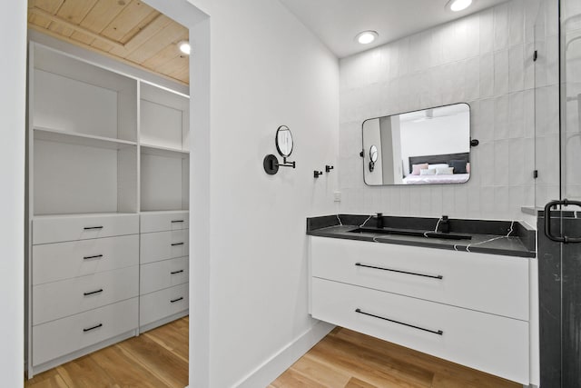 bathroom with wood ceiling, vanity, wood-type flooring, and walk in shower