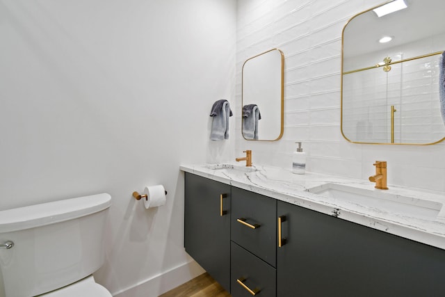 bathroom featuring vanity, toilet, hardwood / wood-style flooring, and a shower with shower door