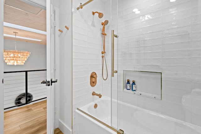 bathroom featuring hardwood / wood-style floors and tiled shower / bath combo