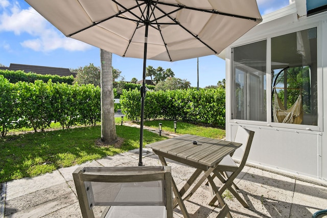 view of patio / terrace featuring a sunroom