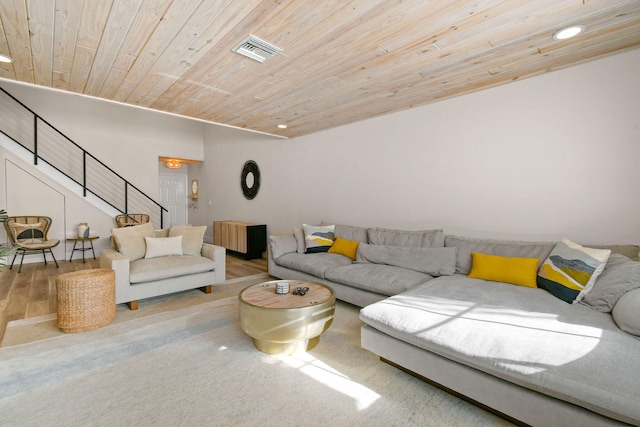 living room with wood ceiling and light colored carpet