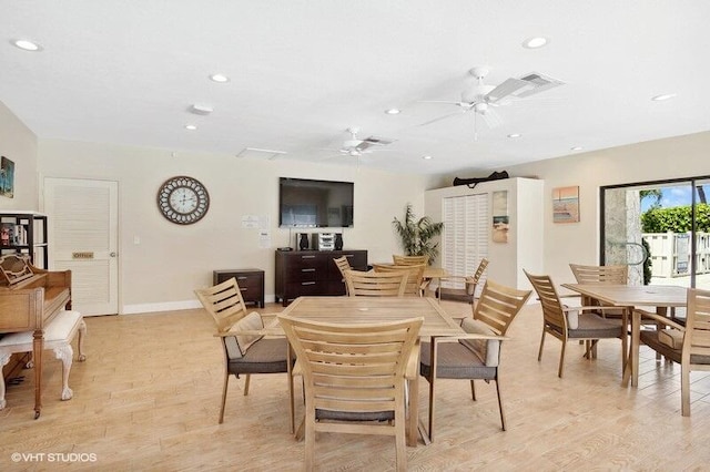 dining space with ceiling fan and light hardwood / wood-style floors