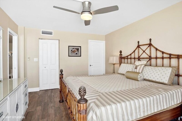 bedroom featuring dark hardwood / wood-style flooring, ceiling fan, and a closet