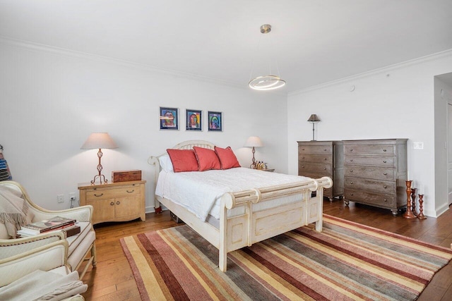 bedroom with dark hardwood / wood-style floors and ornamental molding