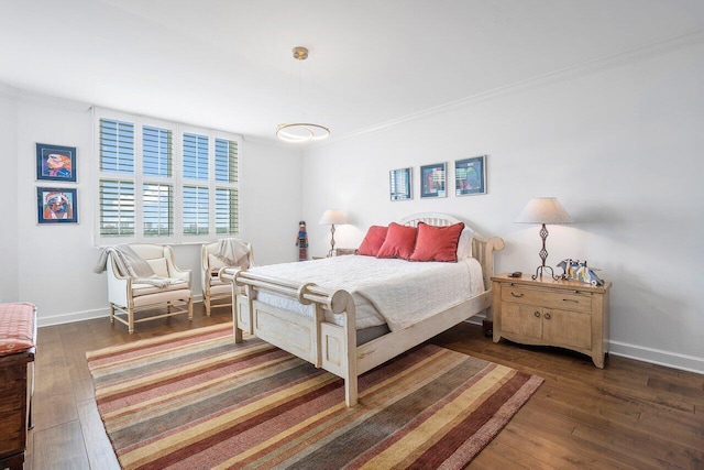 bedroom featuring dark hardwood / wood-style flooring and crown molding