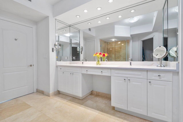 bathroom with walk in shower and vanity