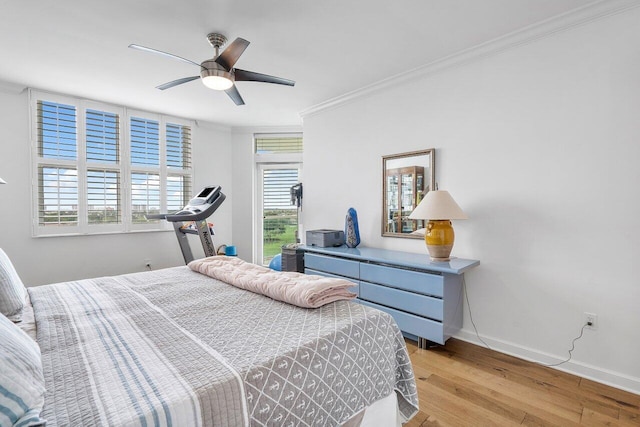 bedroom featuring ceiling fan, ornamental molding, and light hardwood / wood-style flooring